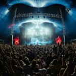 Concert crowd under stage lights (illustrative stock photo)